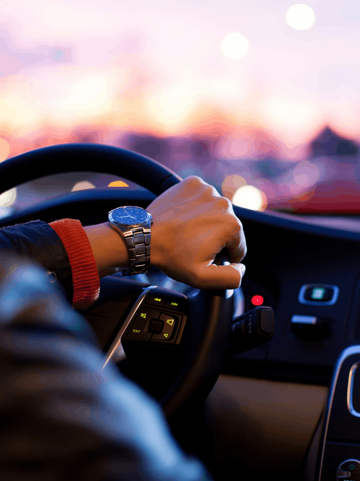 Country highway with mountains on the right and prairies on the left.