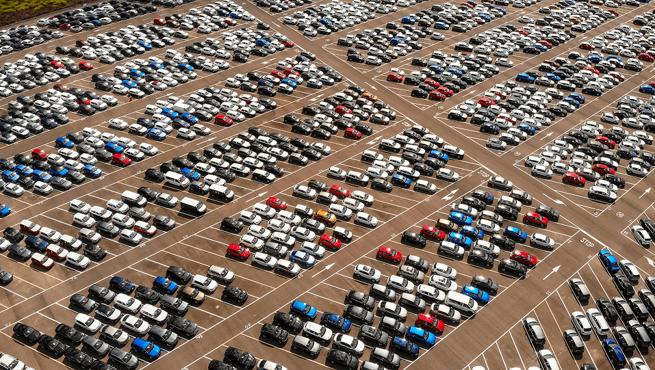 Aerial view of a parking lot full of cars.