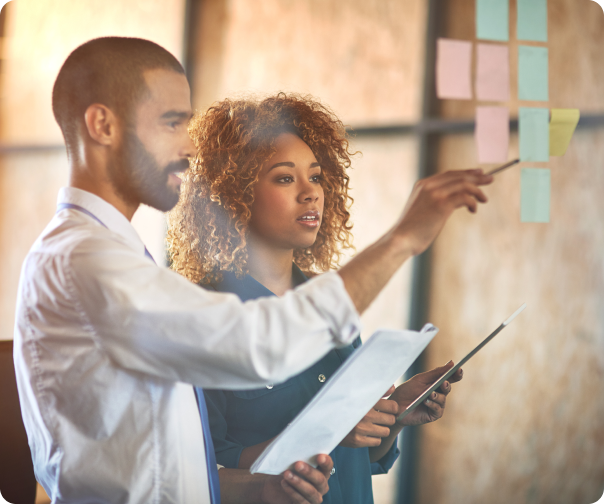 Stock photo of a man and woman working collaboratively on an administrative business task.